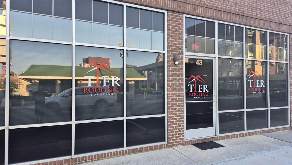 Tier 1 Roofing Solutions logo and window graphics at 43 Church St S, Concord NC